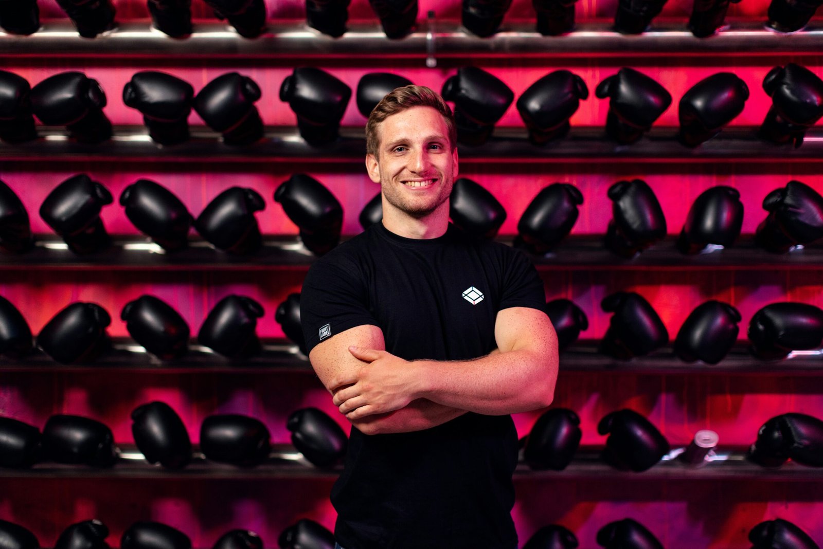 man in black crew neck t-shirt standing near shoes